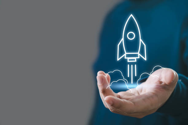 istock A person holds a glowing rocket icon in their hand, symbolizing innovation, technology, and launching new ideas. 2191386432