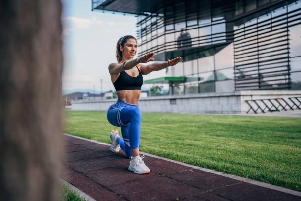 istock Focused woman in vibrant area doing lunge exercises. 2191387312