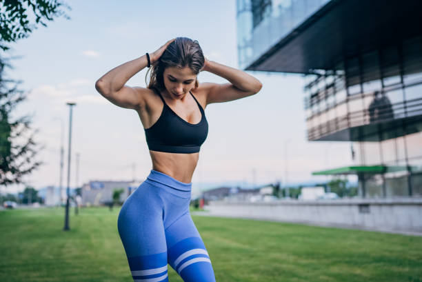istock Athletic woman posing in urban setting wearing blue 2191388528