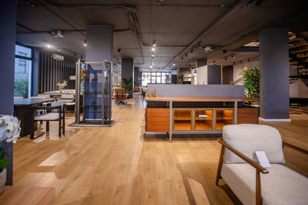 A contemporary office space featuring sleek wooden flooring, open seating arrangements, and modern design elements for a productive work environment.