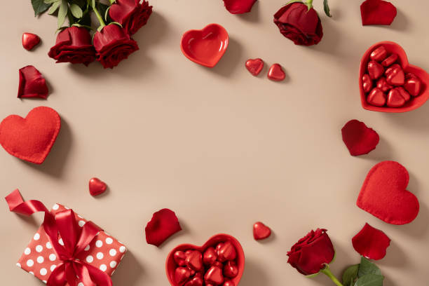 istock Valentine's day frame gift, red roses and candy sweets as heart on beige. 2191390966
