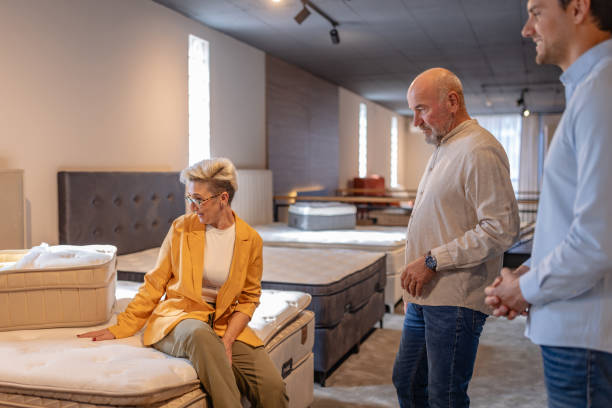 istock Analyzing mattress quality in a furnished showroom. 2191390986