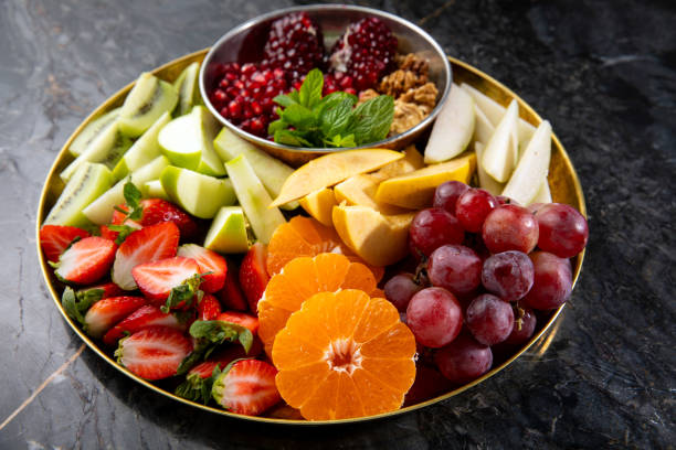 istock Juicy Fruit Salad Plate on the Black Marble Table 2191391354