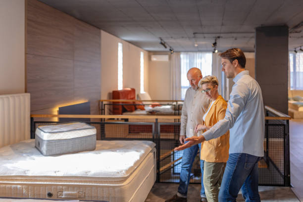 istock Couple examining mattress options in a showroom. 2191392917