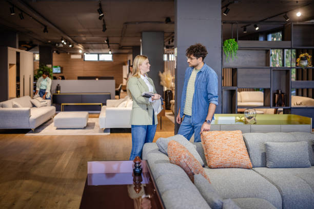 istock Man and woman discuss fabric samples in showroom. 2191393797