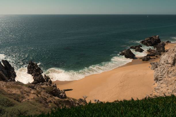 istock Serene coastal view with sandy beach and rocks 2191393874
