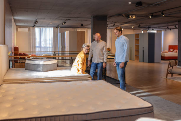 istock Woman examines mattress quality while shopping. 2191394184