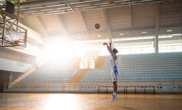 Young Basketball Player Practicing Free Throws Alone on the Court