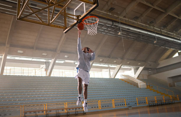 istock Basketball Player Throwing Ball Through Hoop 2191394359