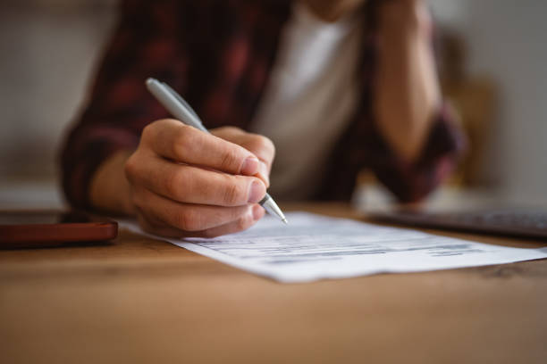 istock close up of man hands write notes in a notebook from laptop at home 2191394458