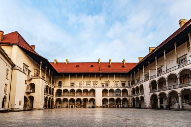 Warsaw, Poland - December 3, 2018: The grand Renaissance courtyard of Wawel Castle captivates with its elegant arcades and harmonious design. Surrounded by intricate columns and arches, the open space embodies the architectural sophistication of the era. A central hub of the castle, it offers a glimpse into the regal lifestyle of Krakow's historical elite.