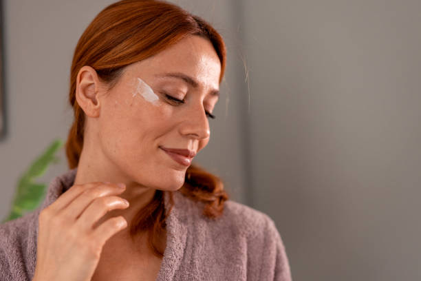 istock Woman applying moisturizer cream on face for beauty treatment 2191395027