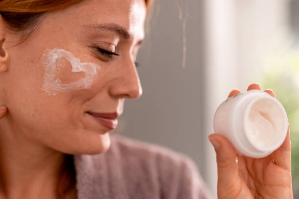 istock Woman applying heart shaped moisturizer on her cheek 2191395227