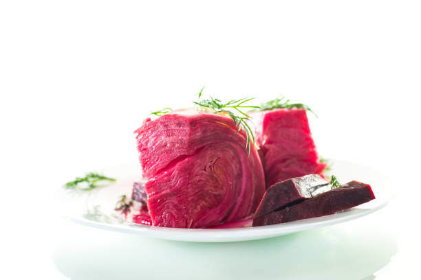 pickled cabbage with beets and carrots, in a plate, isolated on white background .