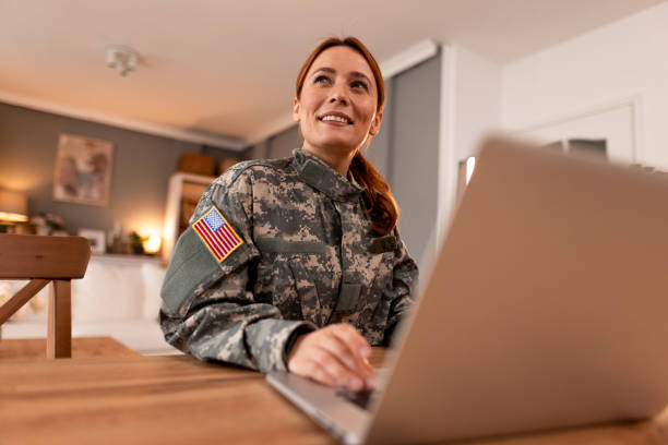 istock Smiling American Soldier Using Laptop at Home 2191395463