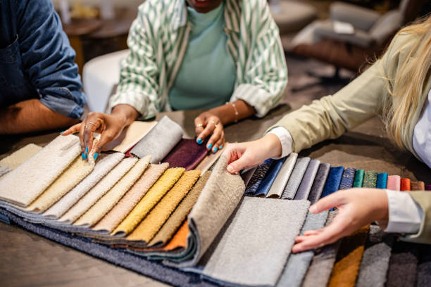 istock Close-up of hands selecting fabric from swatches 2191395732