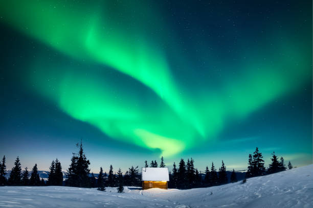 istock Tiny wooden cabin under incredible Northern lights 2191396985