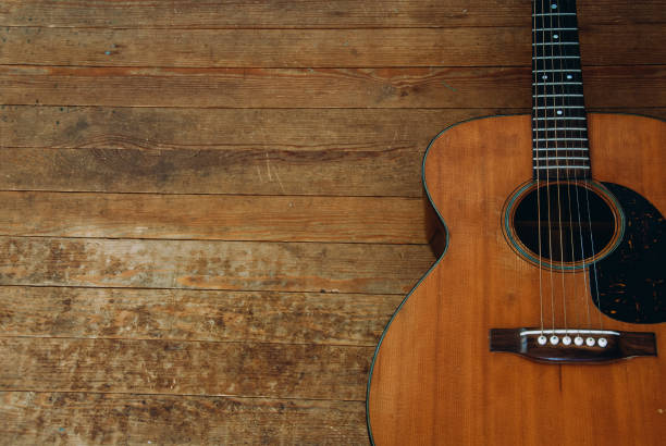 istock Guitar resting on wooden surface in calm indoor setting with natural light shining through 2191397256