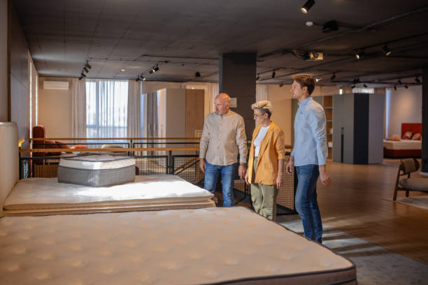 istock Couple deciding on a mattress in store setting. 2191397433