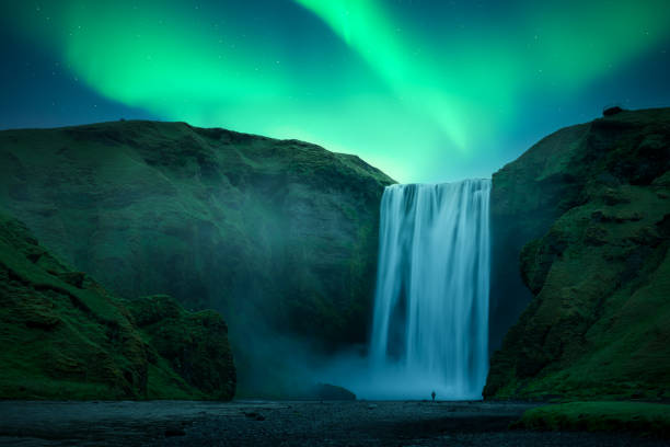 istock Aurora Borealis over famous Skogafoss waterfall on Skoga river 2191397464