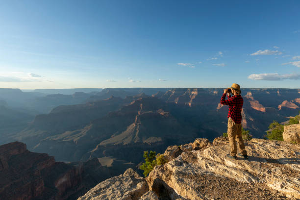 istock Guy looking at binoculars in hill. man in t-shirt with backpack. Young Caucasian man during hike in valley landscape 2191397518
