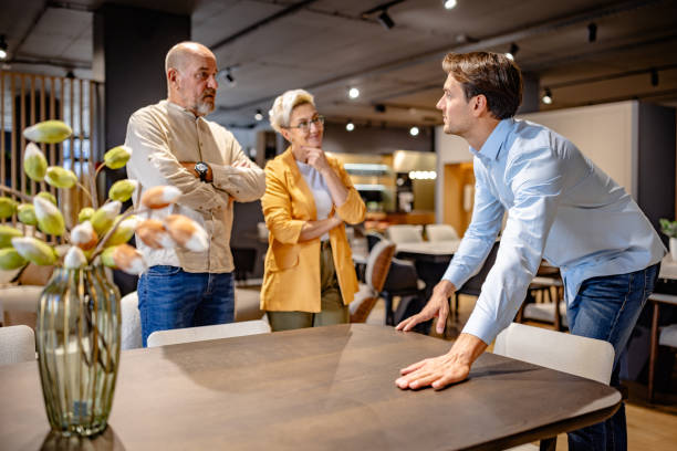 istock Man leans on table talking to attentive couple 2191397722