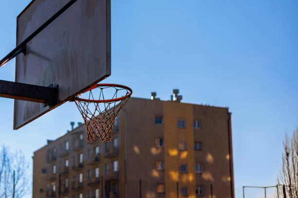 istock Basketball backboard with a basket in front of a multi-storey building. 2191398715