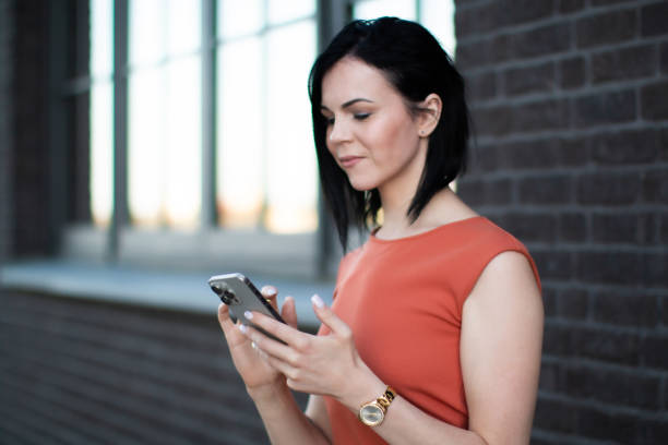 istock Professional woman using smartphone outdoors during business break. 2191400605