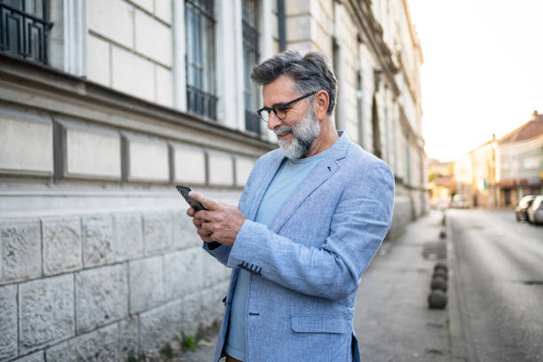 istock Mature man using phone in the city 2191400632