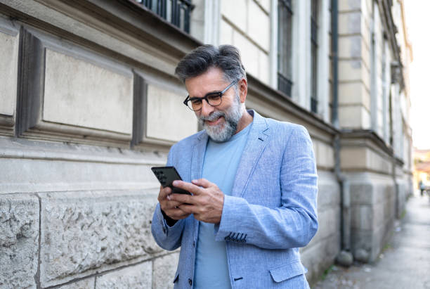 istock Mature man using phone in the city 2191400679