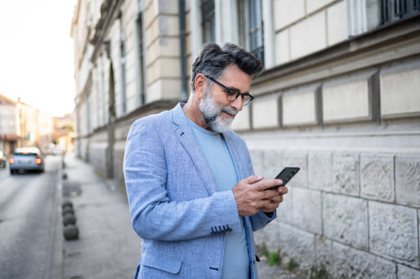 istock Mature man using smartphone outdoors 2191400752