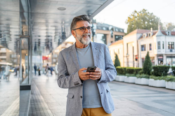 istock Mature man using smartphone outdoors 2191400813