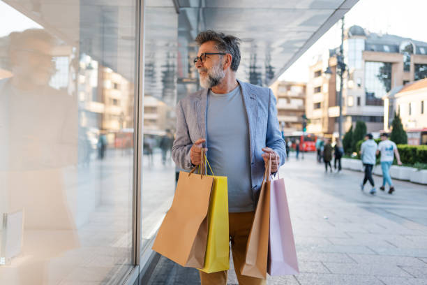 istock Mature man looking at a store window and enjoying shopping 2191400885
