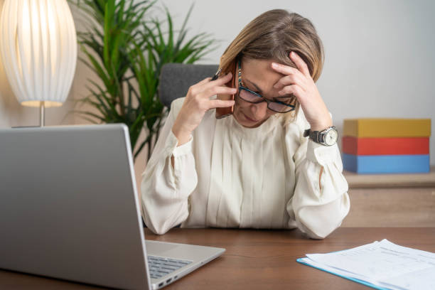 istock Businesswoman sitting at desk looking stressed 2191401881