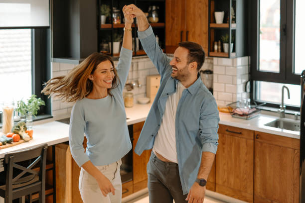 istock Happy couple dancing and having fun in kitchen at home 2191402310