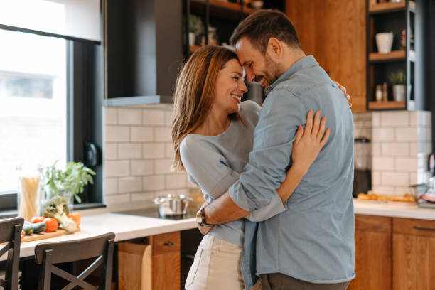 istock Happy couple embracing and dancing in kitchen 2191402312