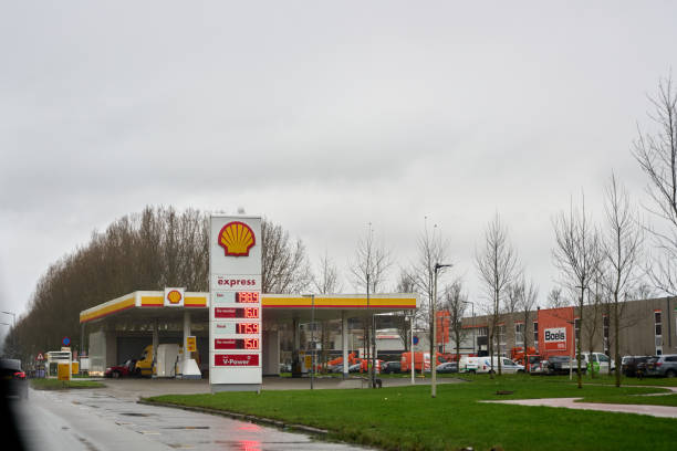 Netherlands, Rotterdam Centrum - 12/19/2024 :  Shell express gas station showing high fuel prices under a cloudy sky