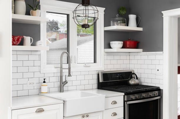 istock A kitchen with grey walls, subway tiles, and a farmhouse sink. 2191403548