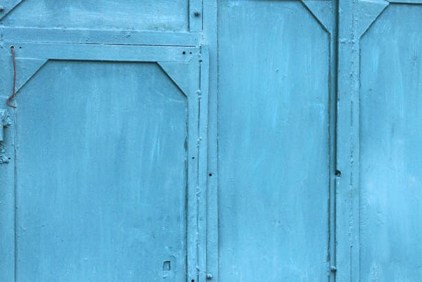 blue metal texture from an old iron wall and door with a seams in the street