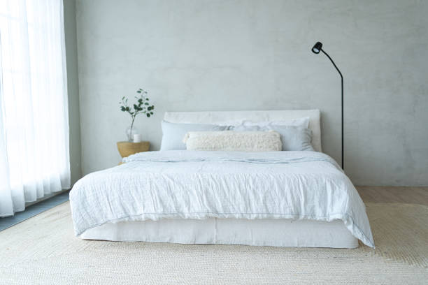 istock Stylish loft bedroom interior. Spacious design apartment with light walls large windows big bed. Clean modern decoration with elegant furniture in minimalist Scandinavian style 2191406957
