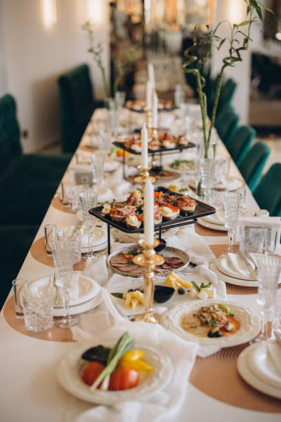 istock Elegant wedding table setting with appetizers, candles and lucky bamboo 2191407585