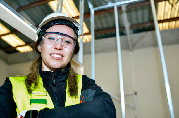 Portrait of a confident female construction worker smiling on a building site