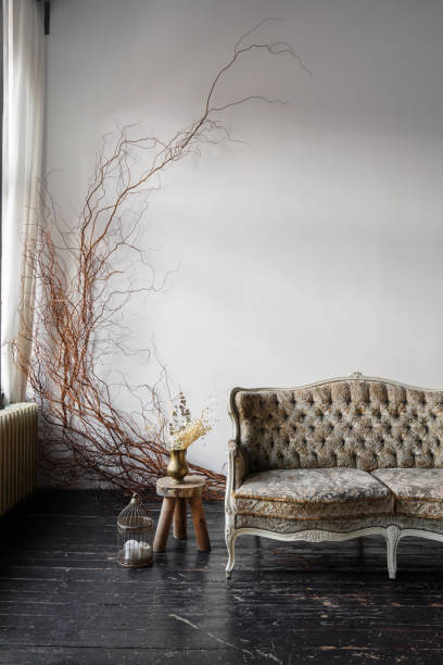 istock Elegant vintage sofa with decorative branches in a stylish living room setting 2191407737
