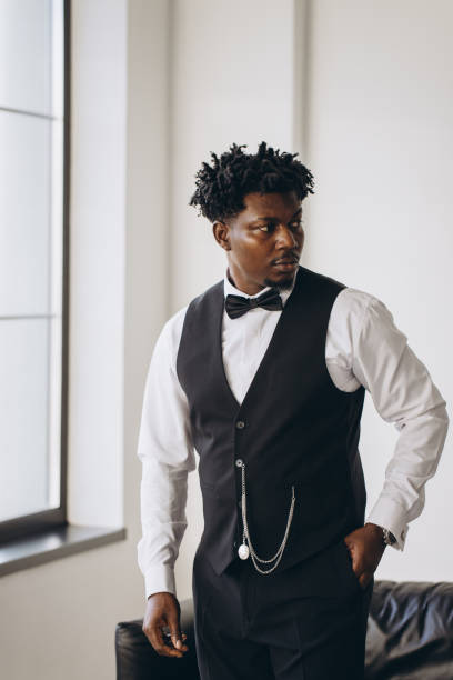 istock Elegant groom wearing suit and bow tie getting ready for wedding ceremony 2191407810