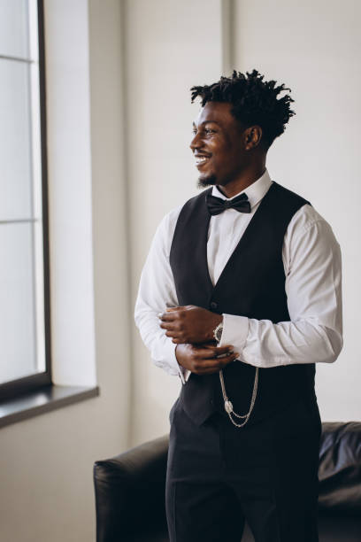 istock Elegant groom adjusting sleeves while getting ready for wedding 2191407811