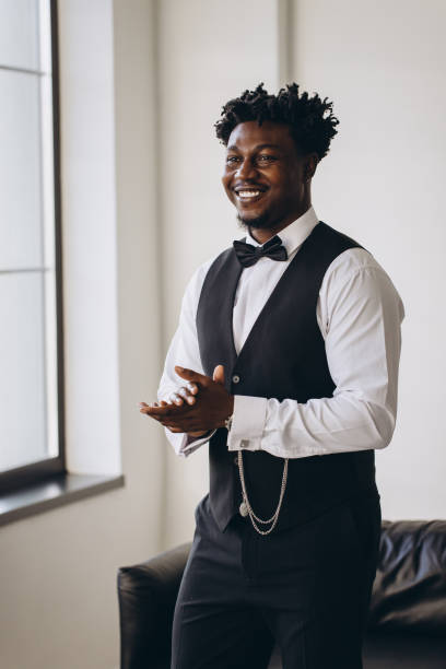 istock Elegant groom rubbing his hands and smiling before wedding 2191407816