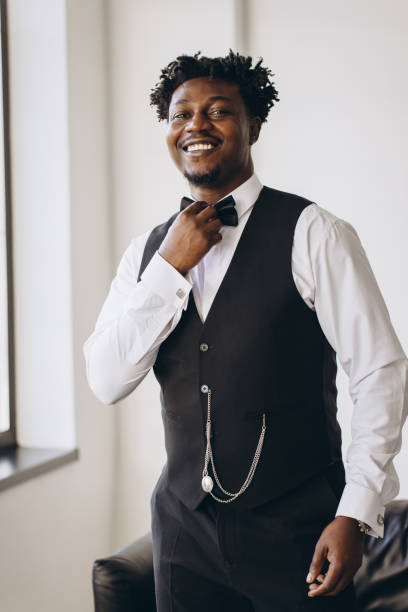 istock Elegant groom adjusting bow tie, getting ready for wedding ceremony 2191407823