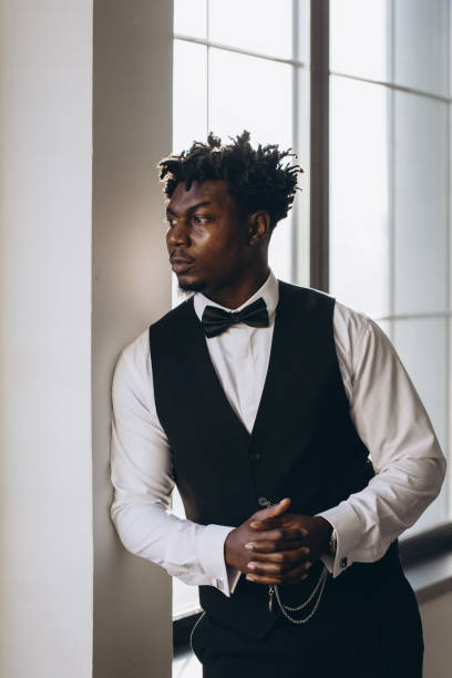 istock Elegant groom waiting and looking out the window 2191407831