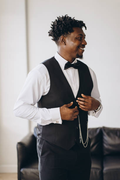 istock Elegant groom adjusting waistcoat while getting ready for wedding ceremony 2191407838