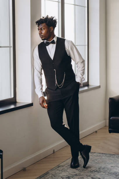 istock Elegant groom looking out the window while waiting for the bride 2191407850